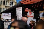 People at a protest hold up signs that say "Stop AAPI Hate," "Stop Attacks on Asian Seniors" and "Stop Violence"