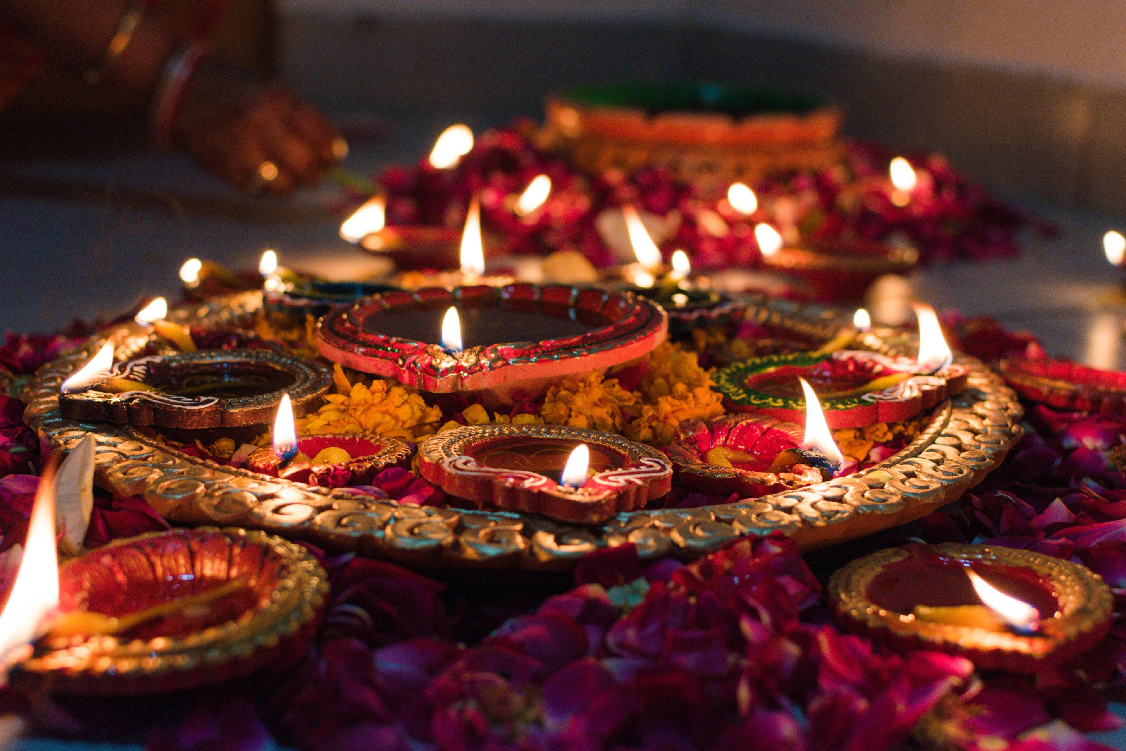 Candles and colorful flowers laid out for Diwali