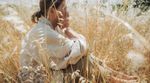 Woman dealing with summer sadness in field