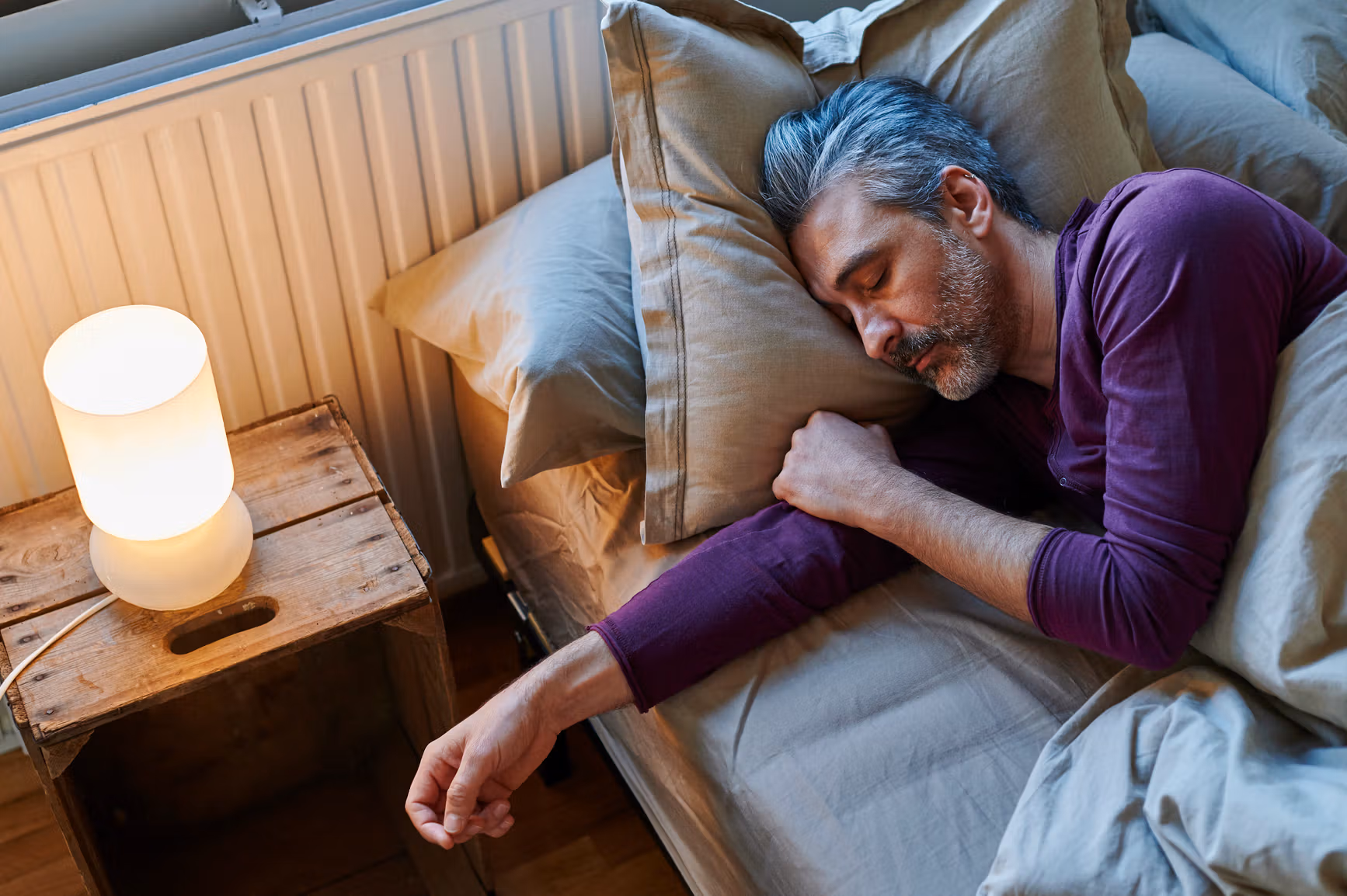 man asleep in bed