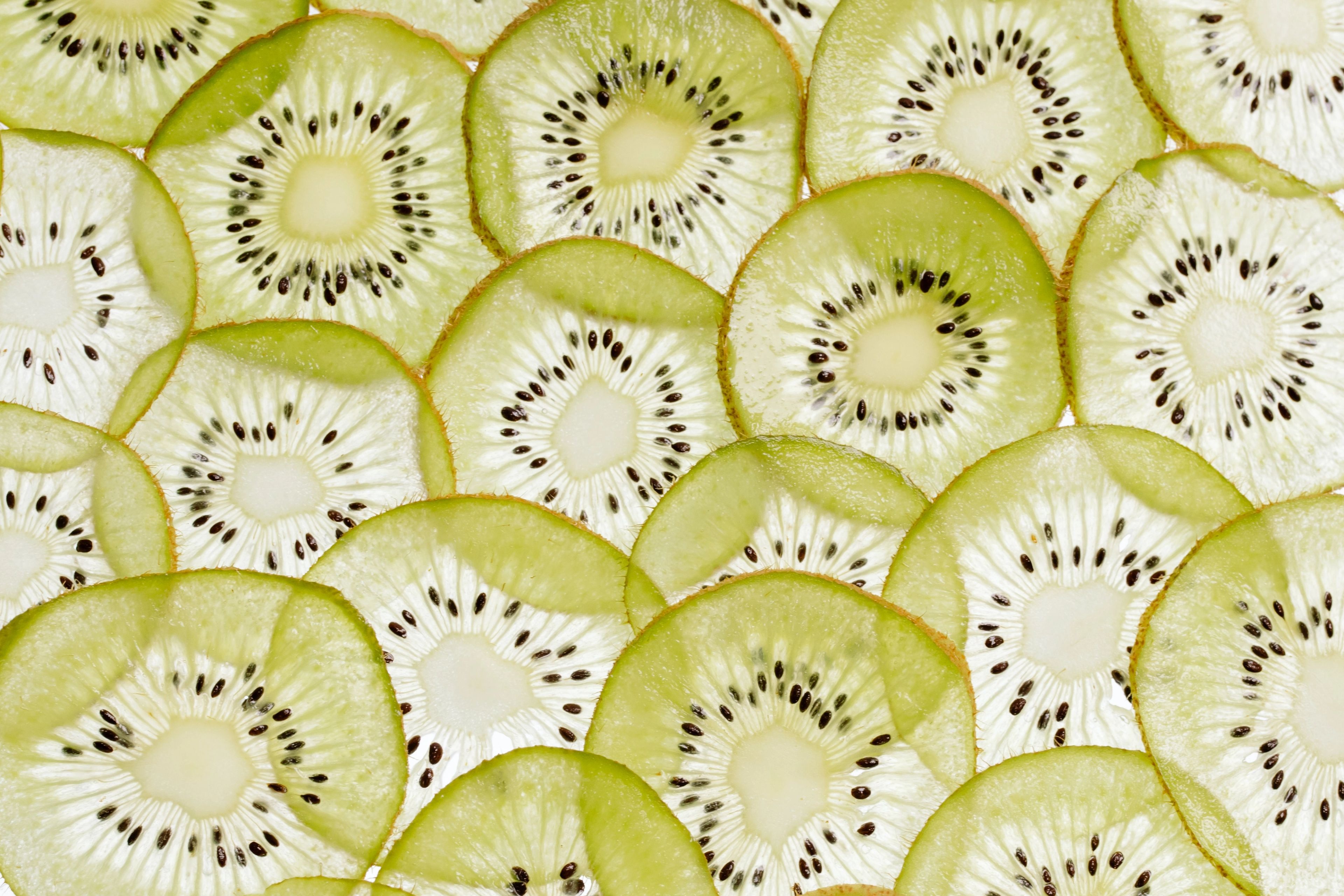 Kiwi slices on a white surface
