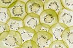 Kiwi slices on a white surface