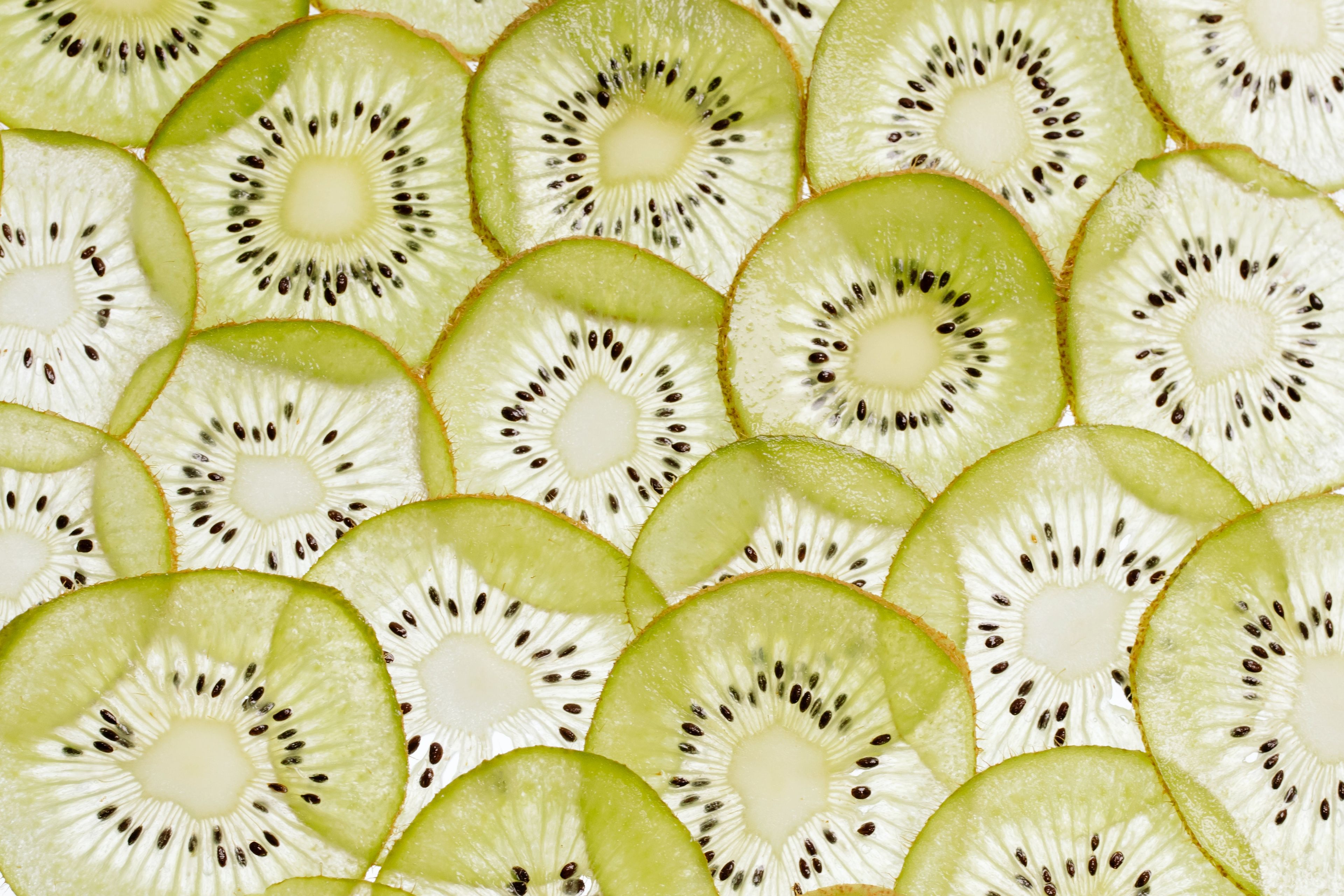 Kiwi slices on a white surface