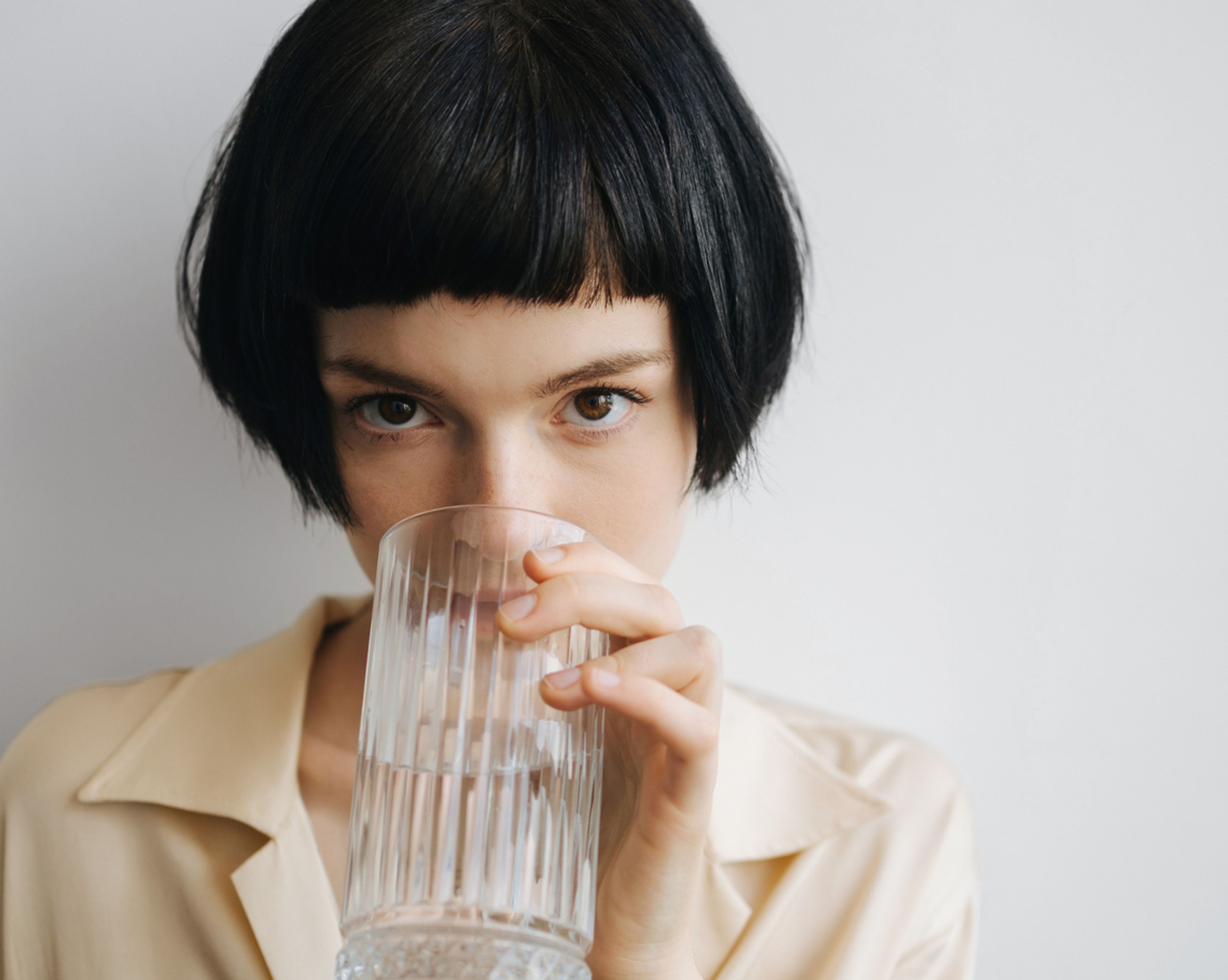 woman drinking a glass of water