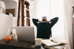 man stretching at computer
