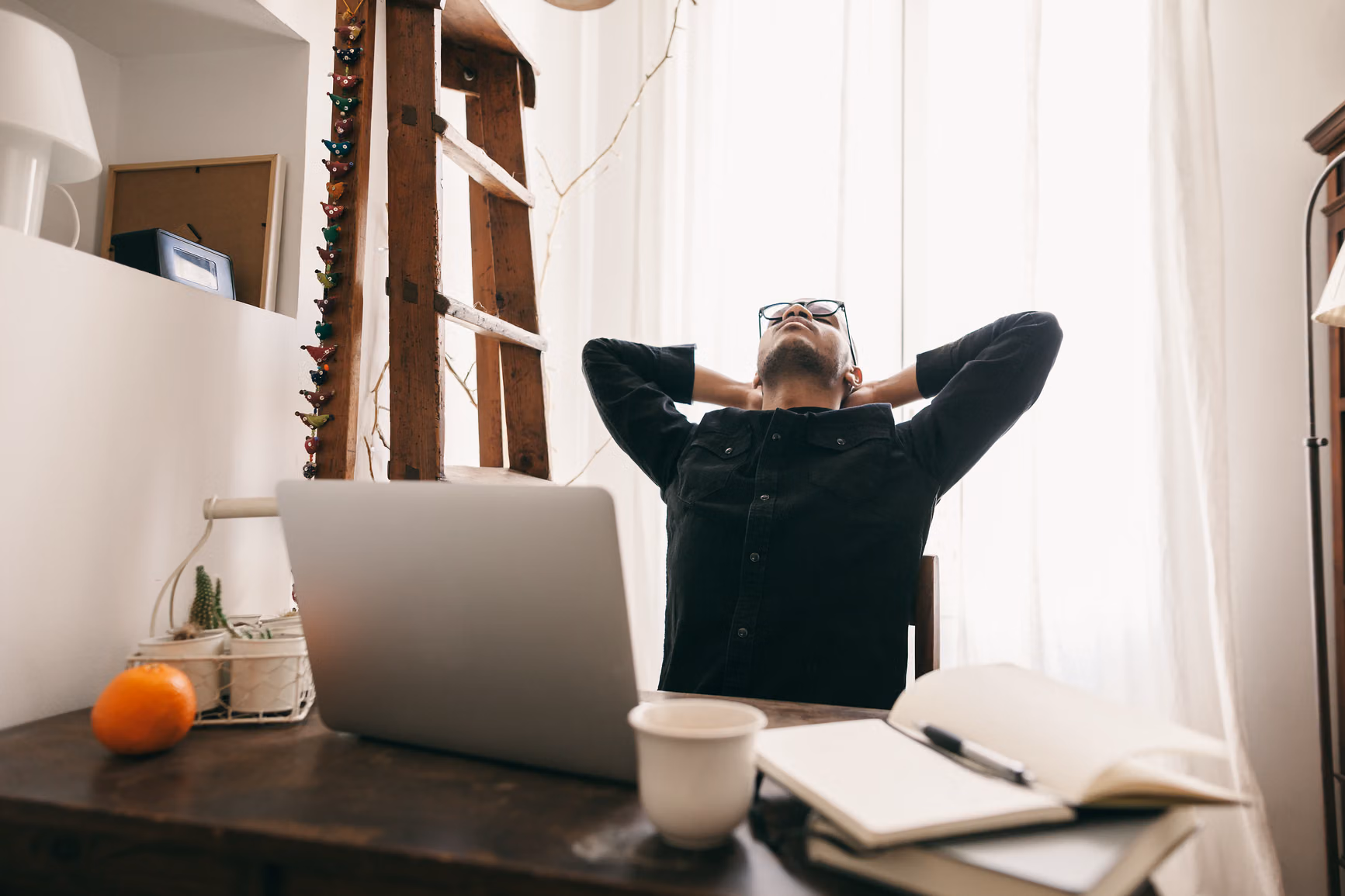 man stretching at computer
