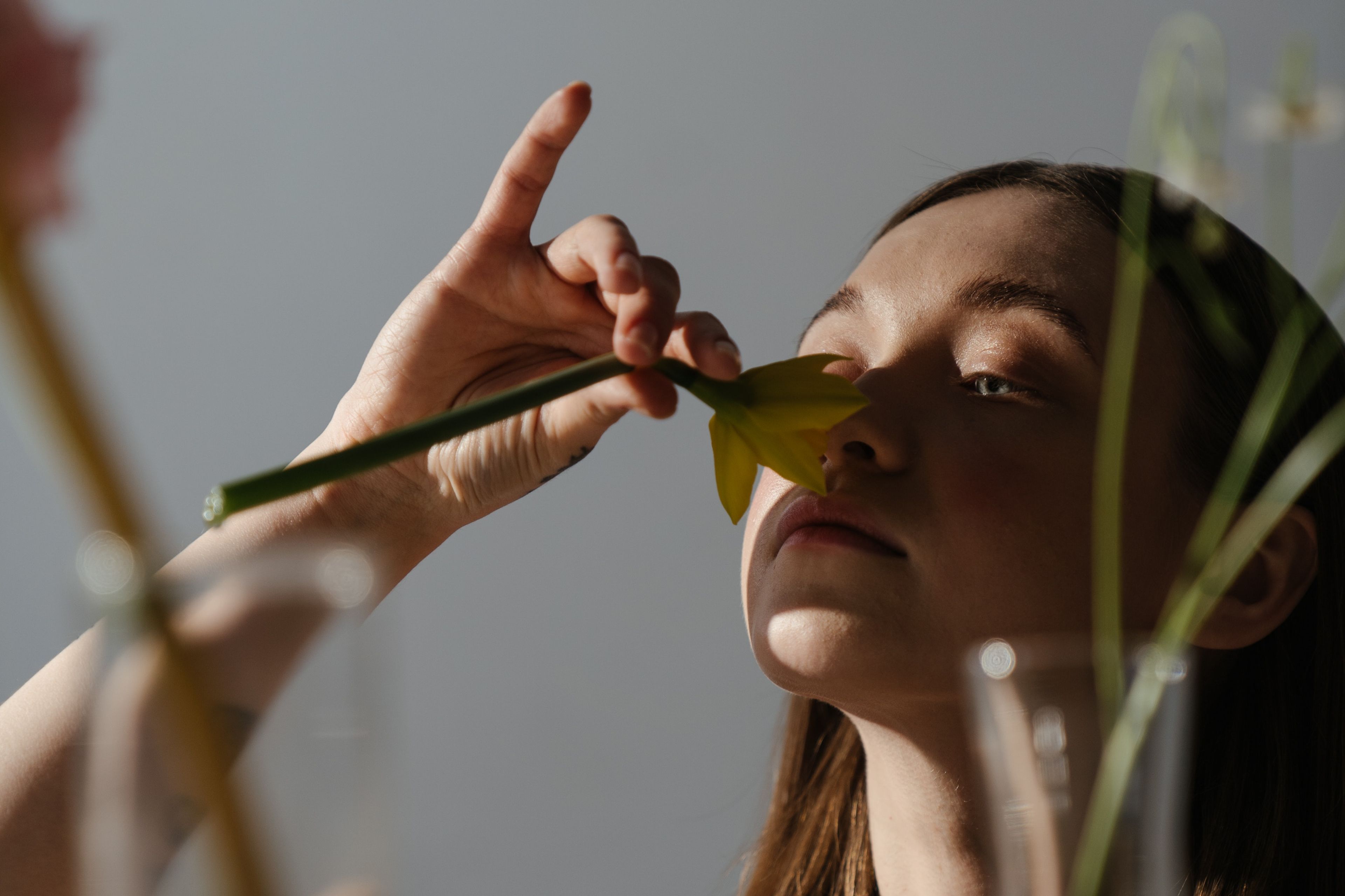 Woman smells a daffodil