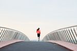 woman running on the bridge