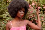 Black woman with afro in a garden