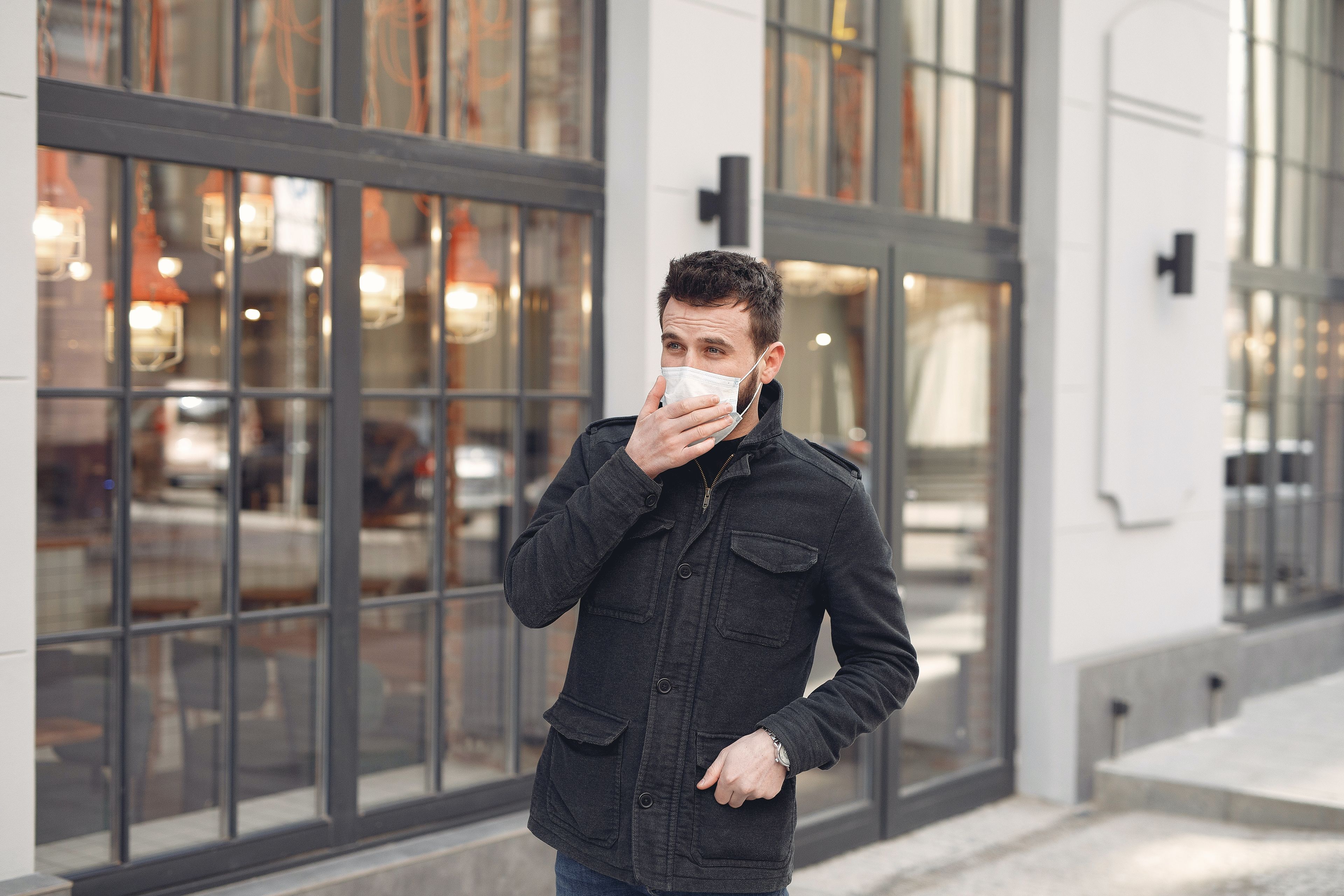 man in mask on city street