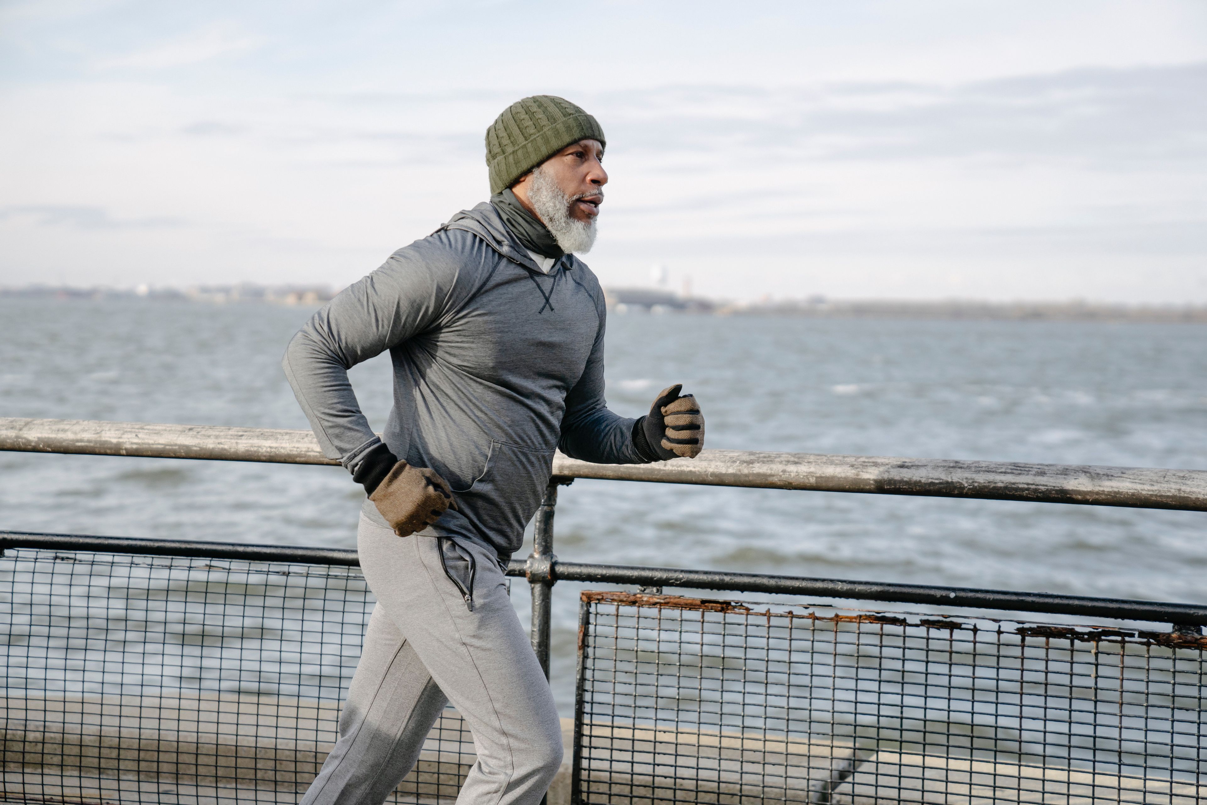 Older man running by water