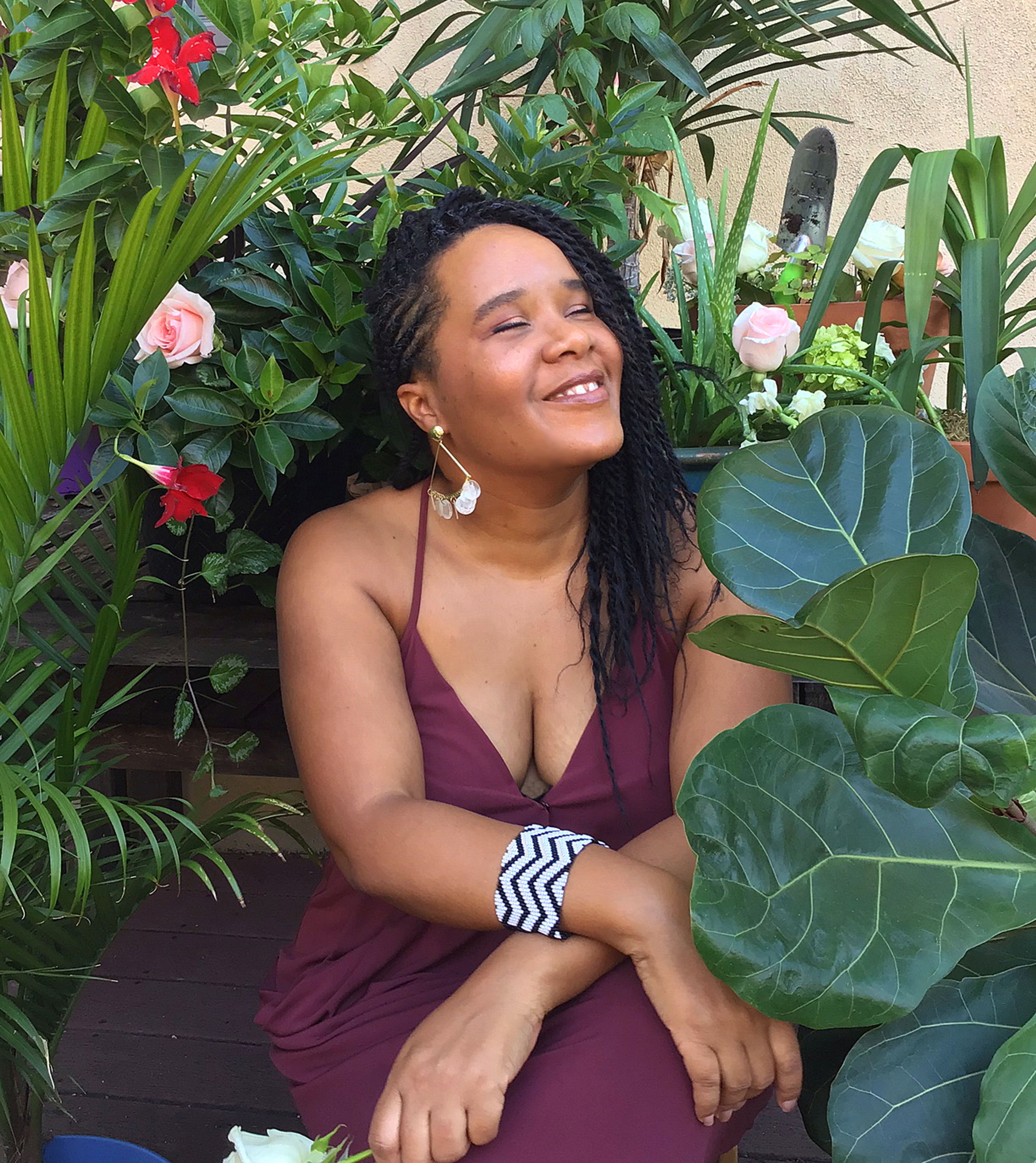 Niambi Cacchioli smiling in a garder