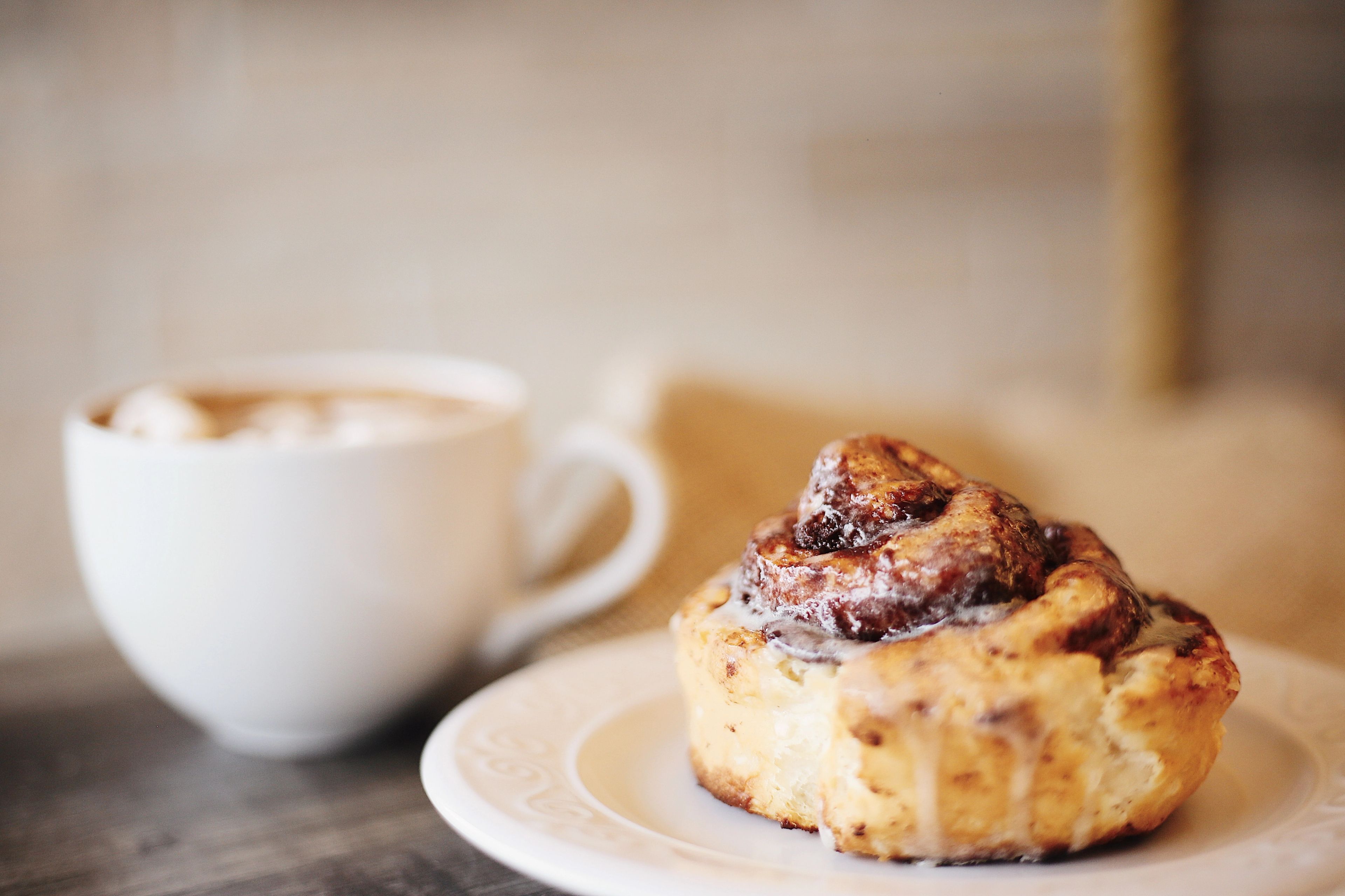 Coffee cup and cinnamon bun