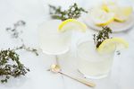 Two mocktails with lemon and thyme