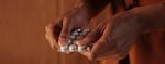 Woman's hands holding blister pack of medication 