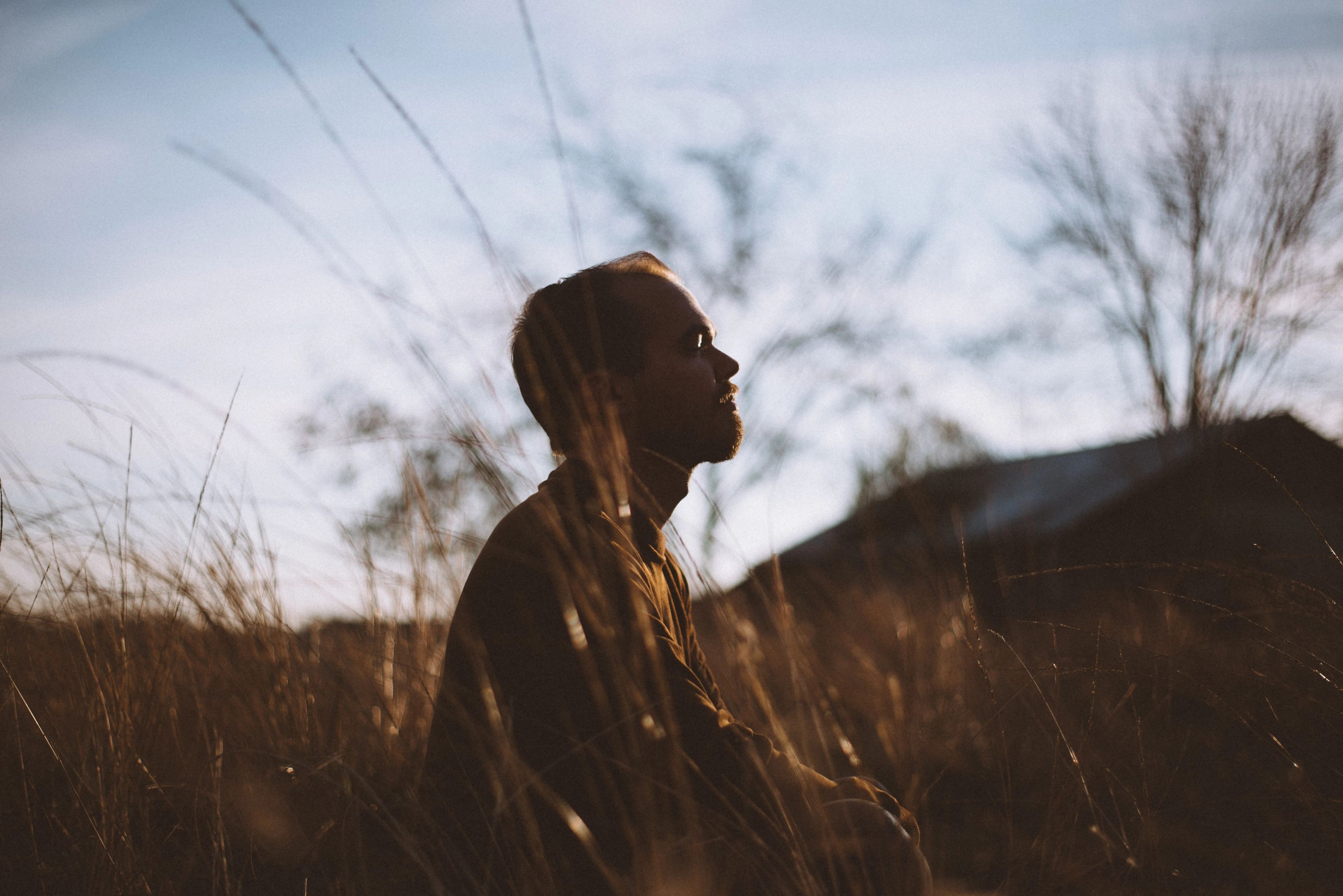 man sitting in a field peacefully