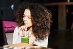 woman drinking green juice