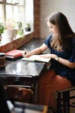 woman writing at window