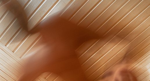 Abstract illustration of red light therapy with glowing red beams, representing its wellness and anti-aging benefits
