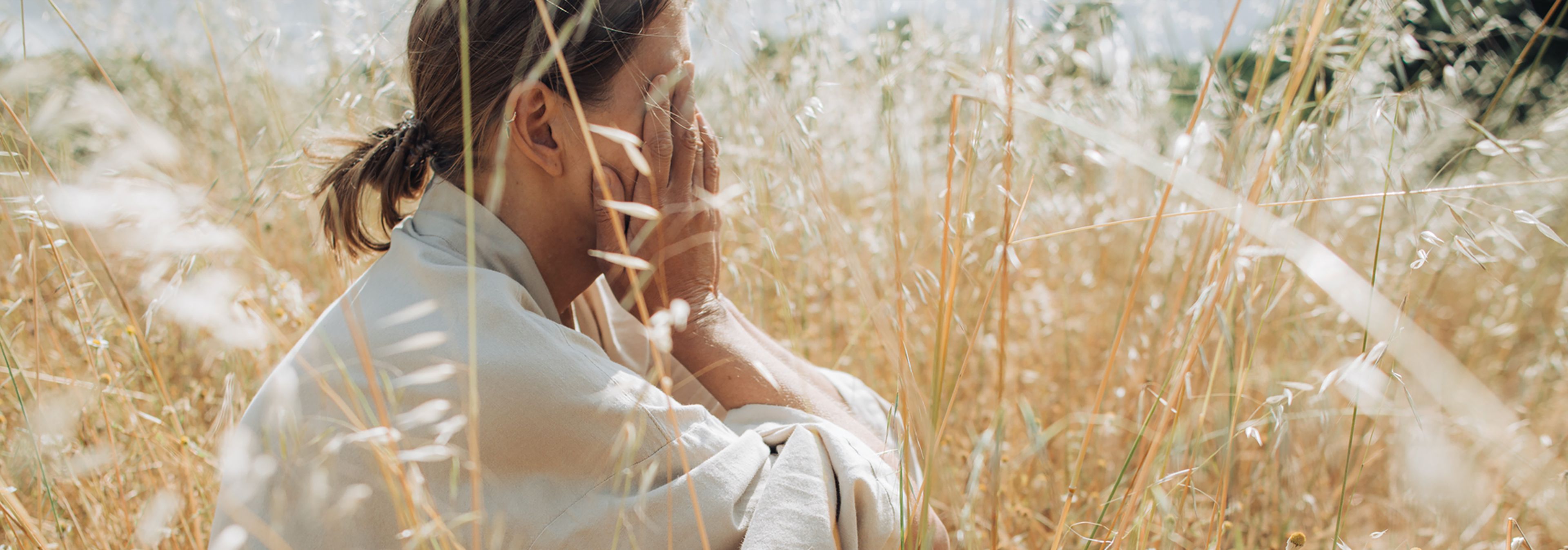 Woman dealing with summer sadness in field