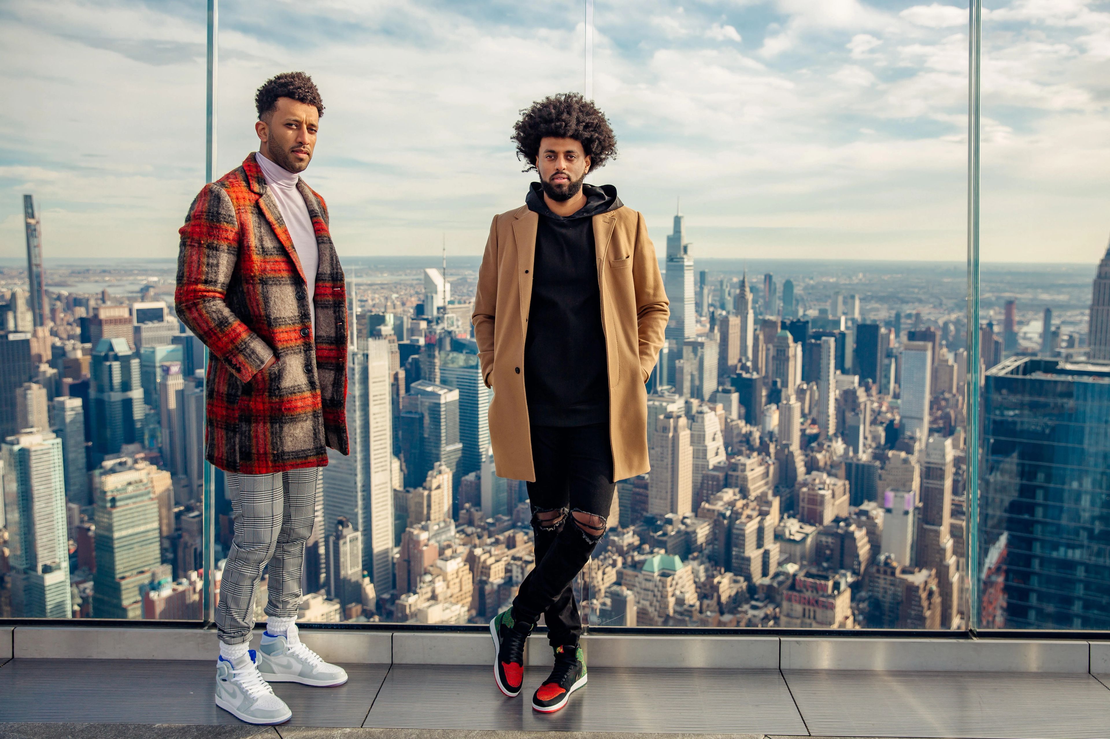 Founders of Foy: Moose and Yon Haile standing on the top of a NYC skyscraper