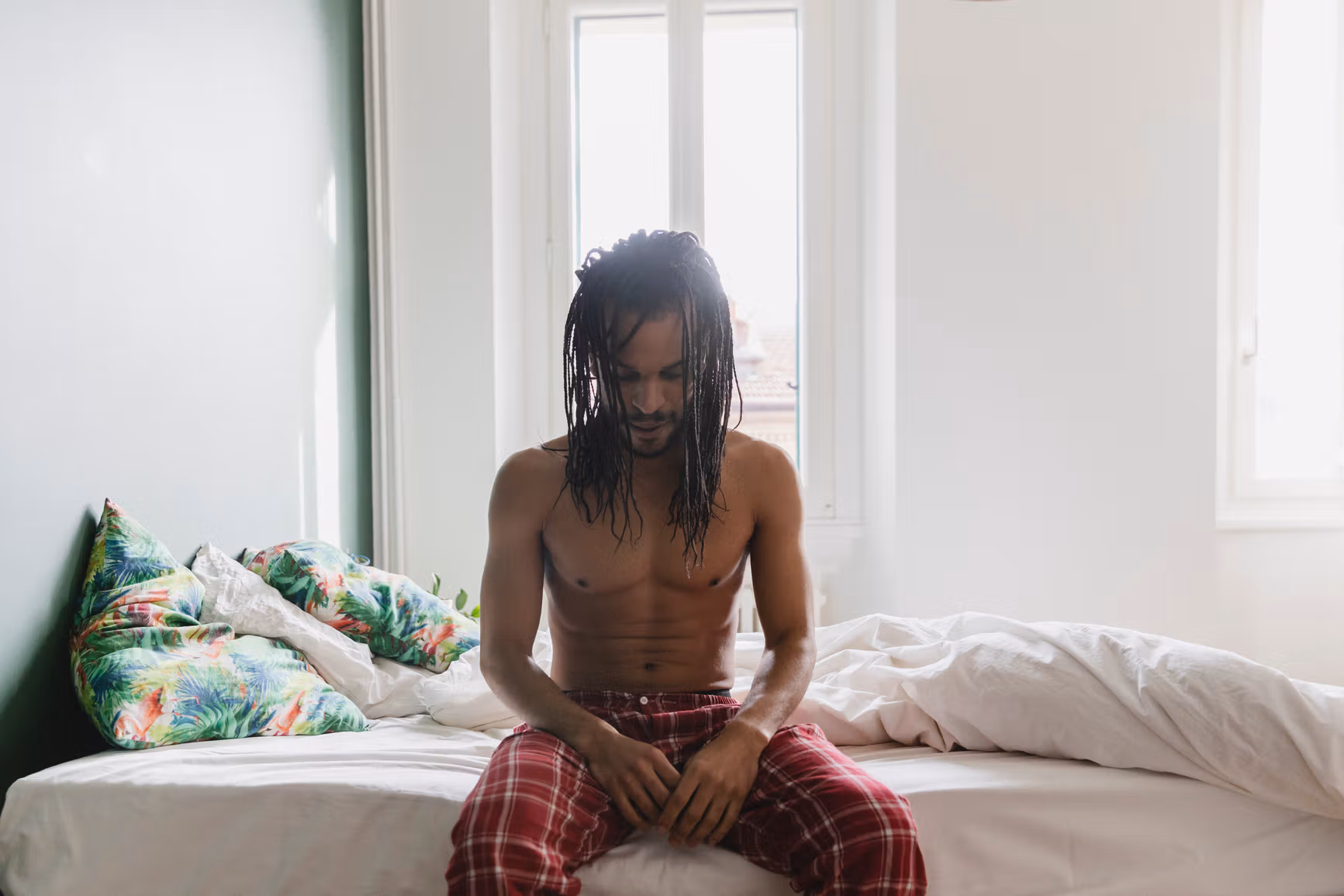 Man sleeping on bed doing breathing exercises for sleep.