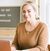 Terri Cole sits at her laptop and smiles.