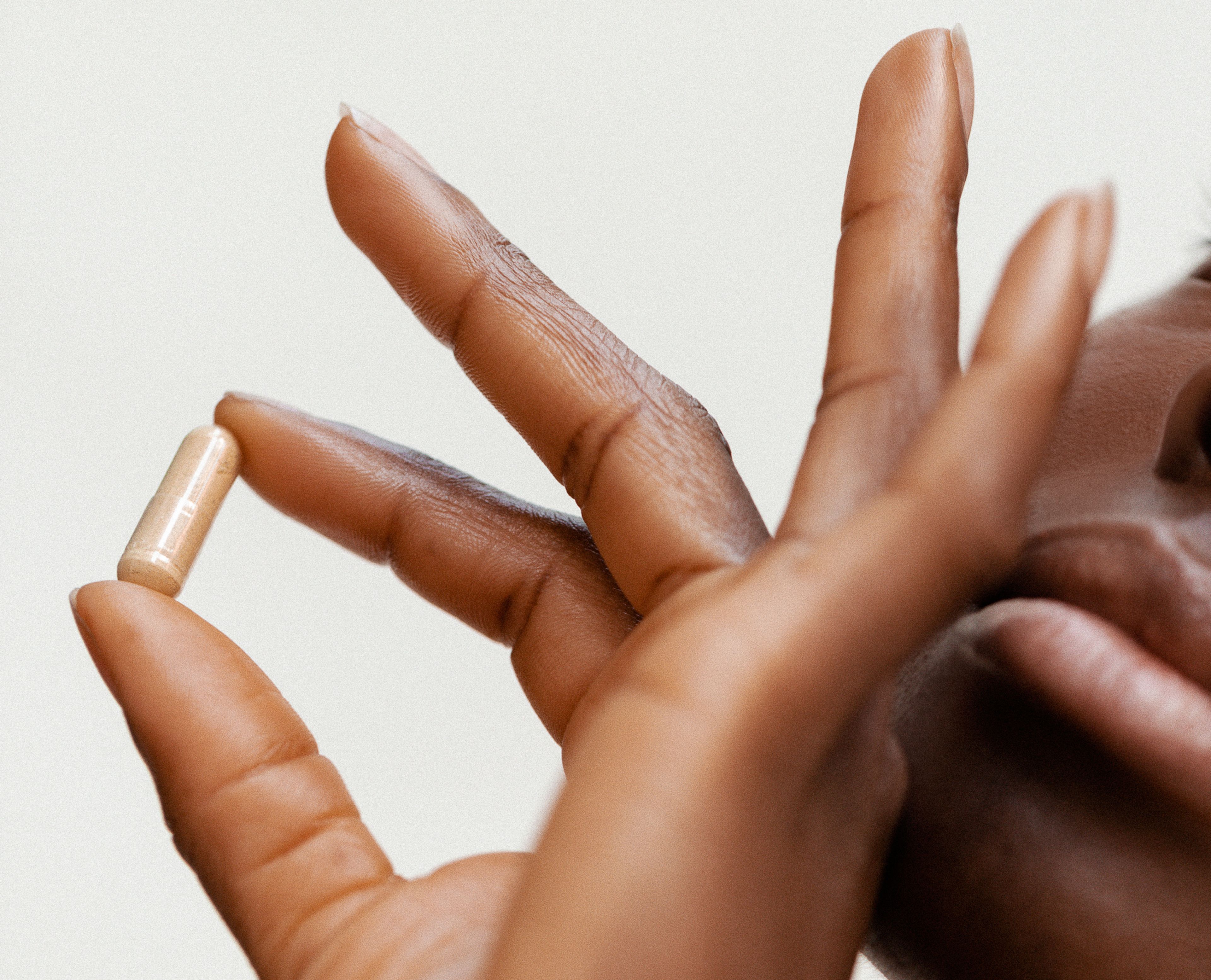 close up of hand holding pill