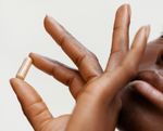 close up of hand holding pill