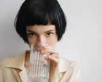 woman drinking a glass of water