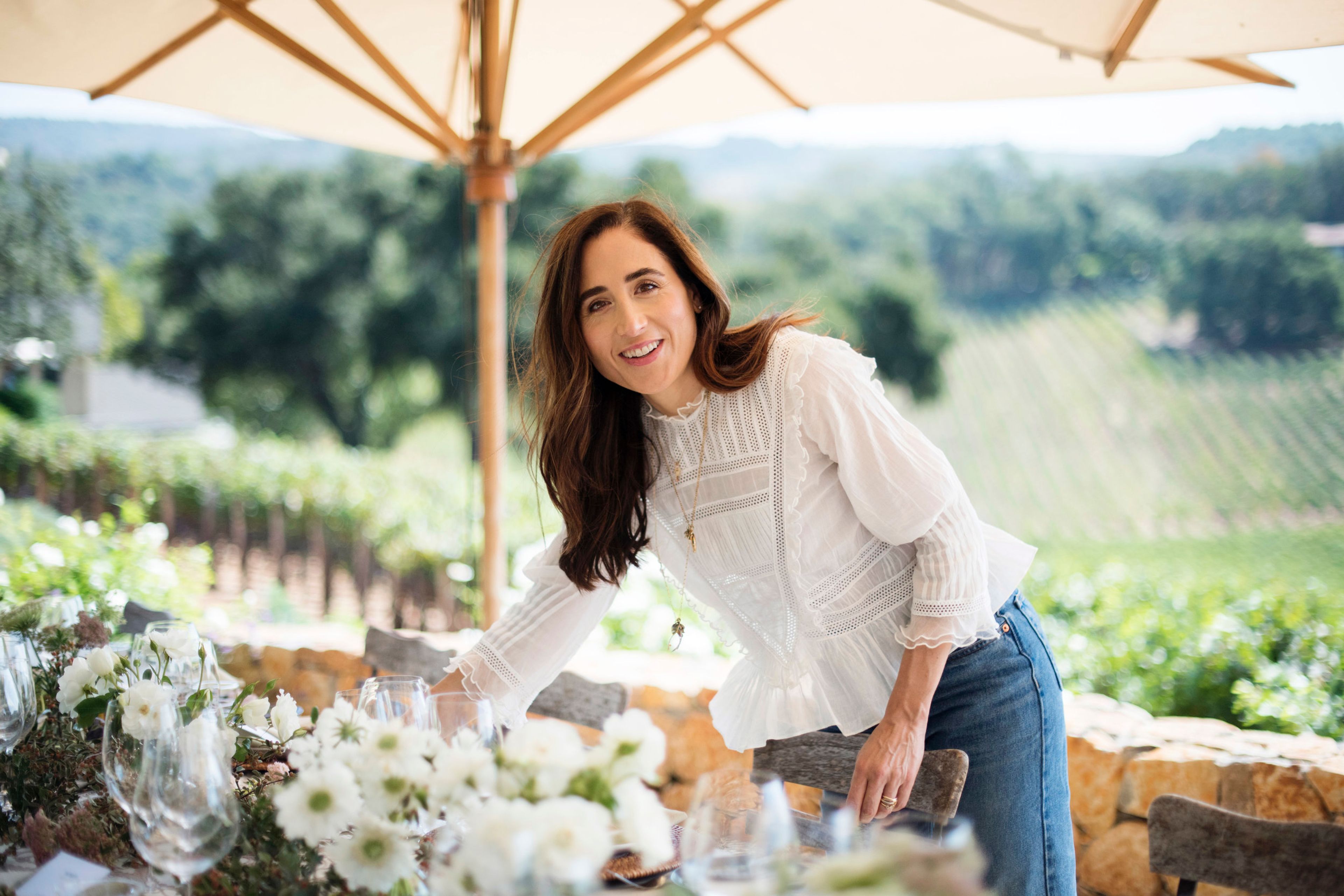 April Gargiulo at a table in a vineyard