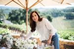 April Gargiulo at a table in a vineyard