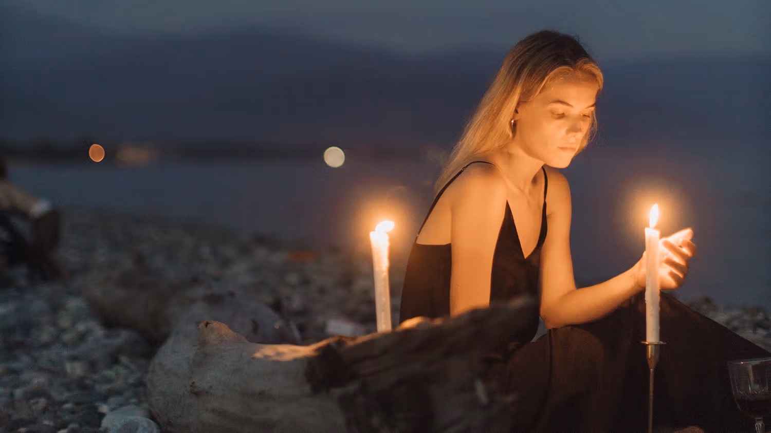 Woman with candles on the beach