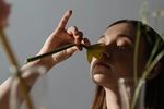 Woman smells a daffodil