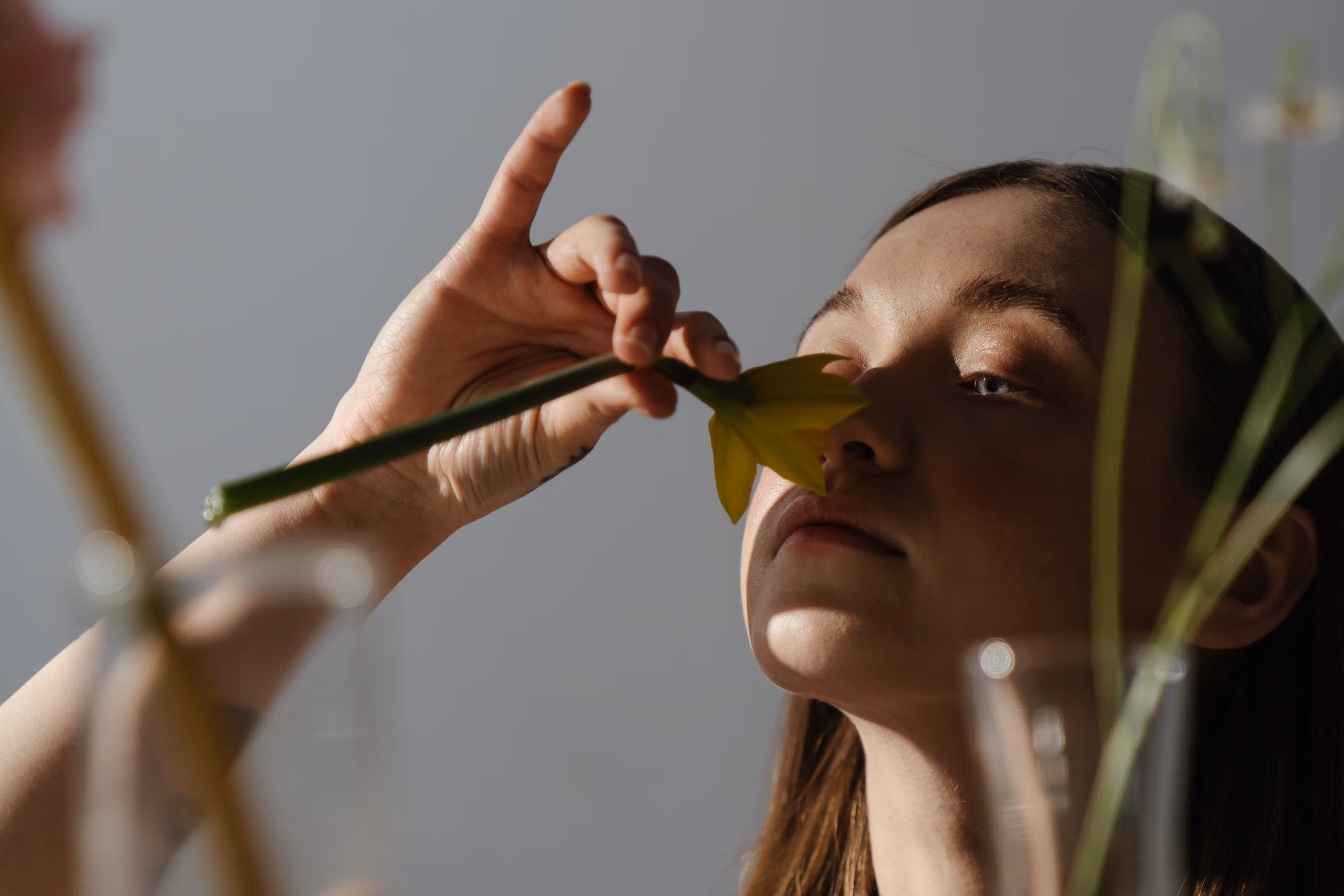 Woman smells a daffodil