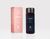On the left, there is a rose pink short and rectangular box with a label that reads Pause, breathe, balance and reset BODY OIL, BERGAMOT MINT, YLANG YLANG, THE WELL logo and 100ml/3.4oz. On the right of the box is a dark-tinted bottle with a black seal and a navy-colored label that reads reset BODY OIL, BERGAMOT MINT, YLANG YLANG, THE WELL logo and 100mi/3.4oz.