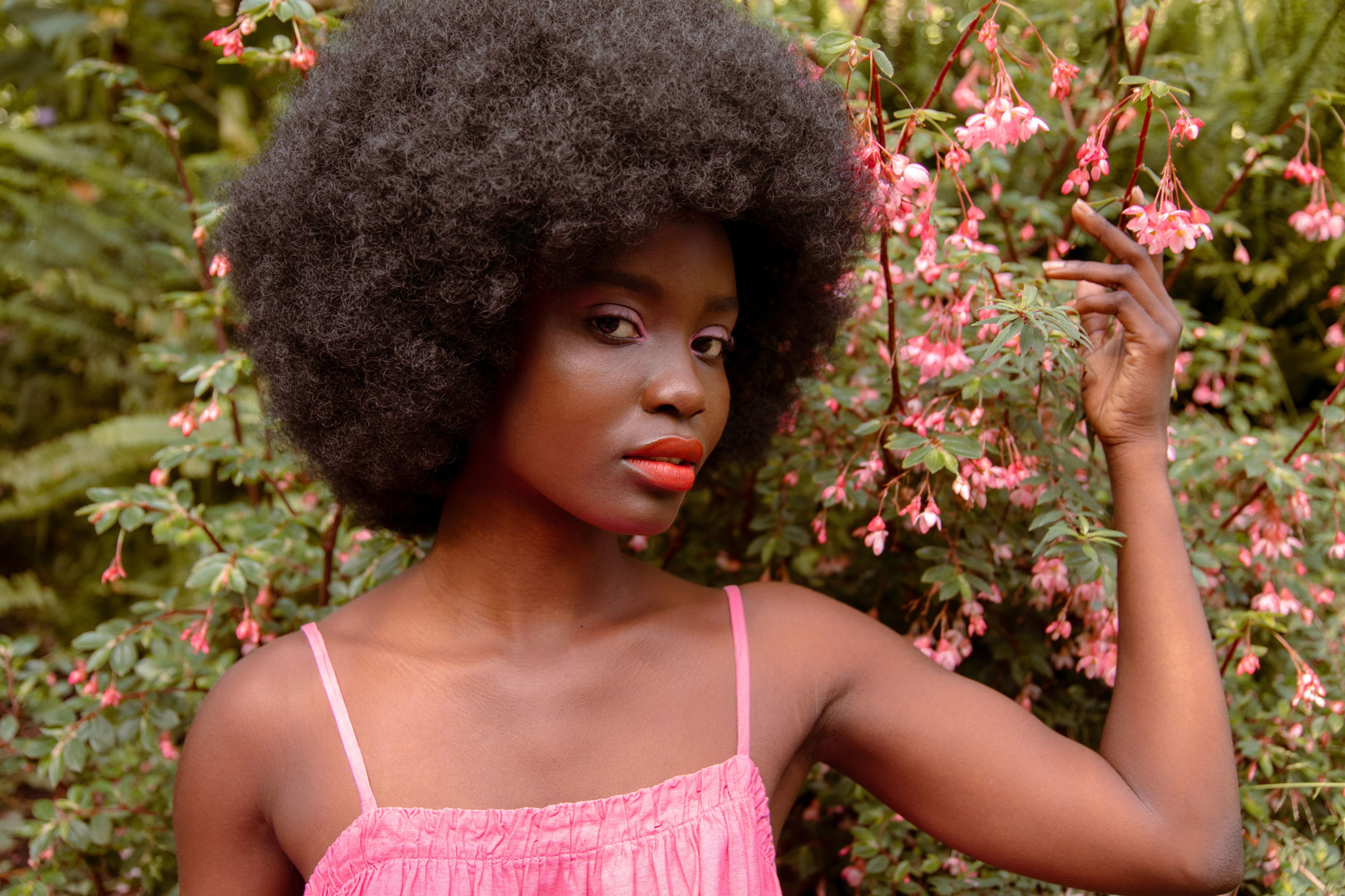Black woman with afro in a garden