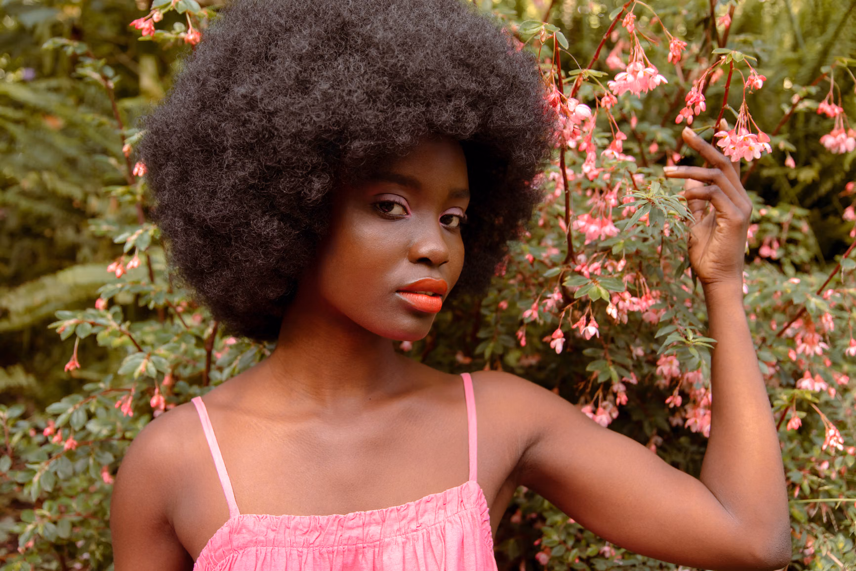 Black woman with afro in a garden