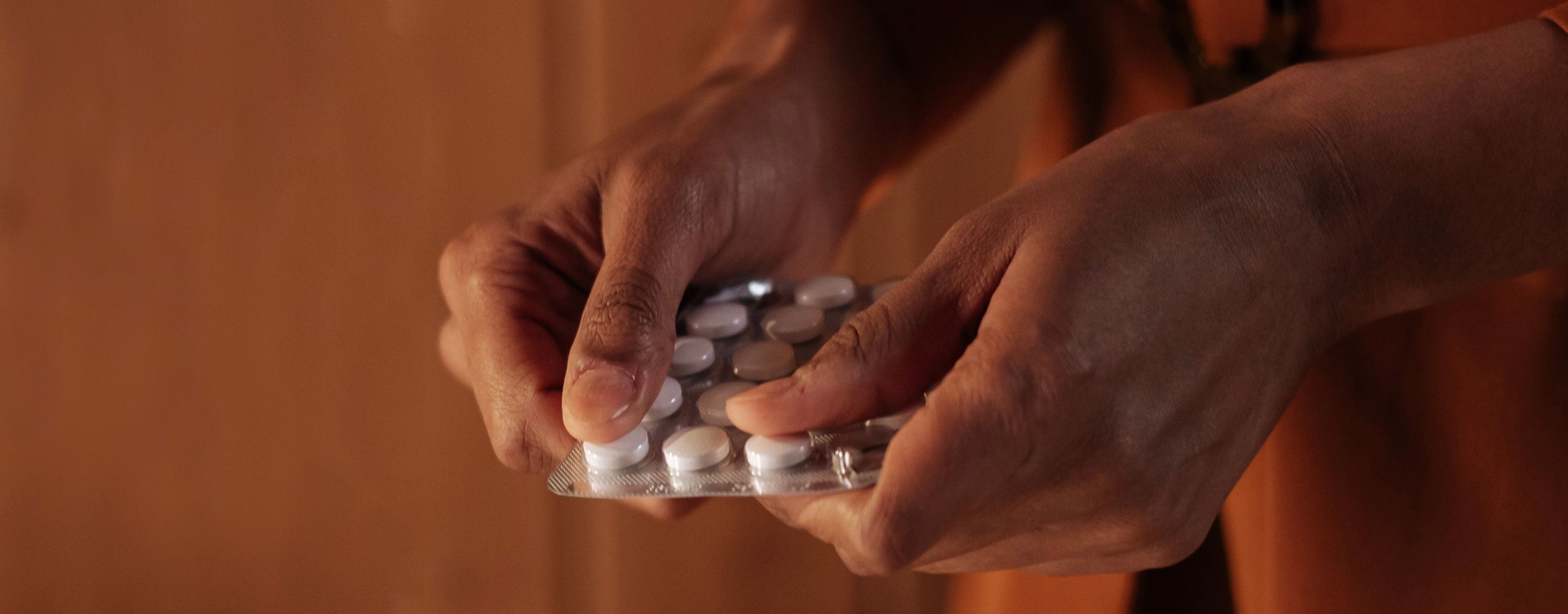 Woman's hands holding blister pack of medication