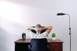 Guy sitting at desk with hands on his head