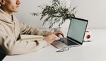 A man sits at desk with computer