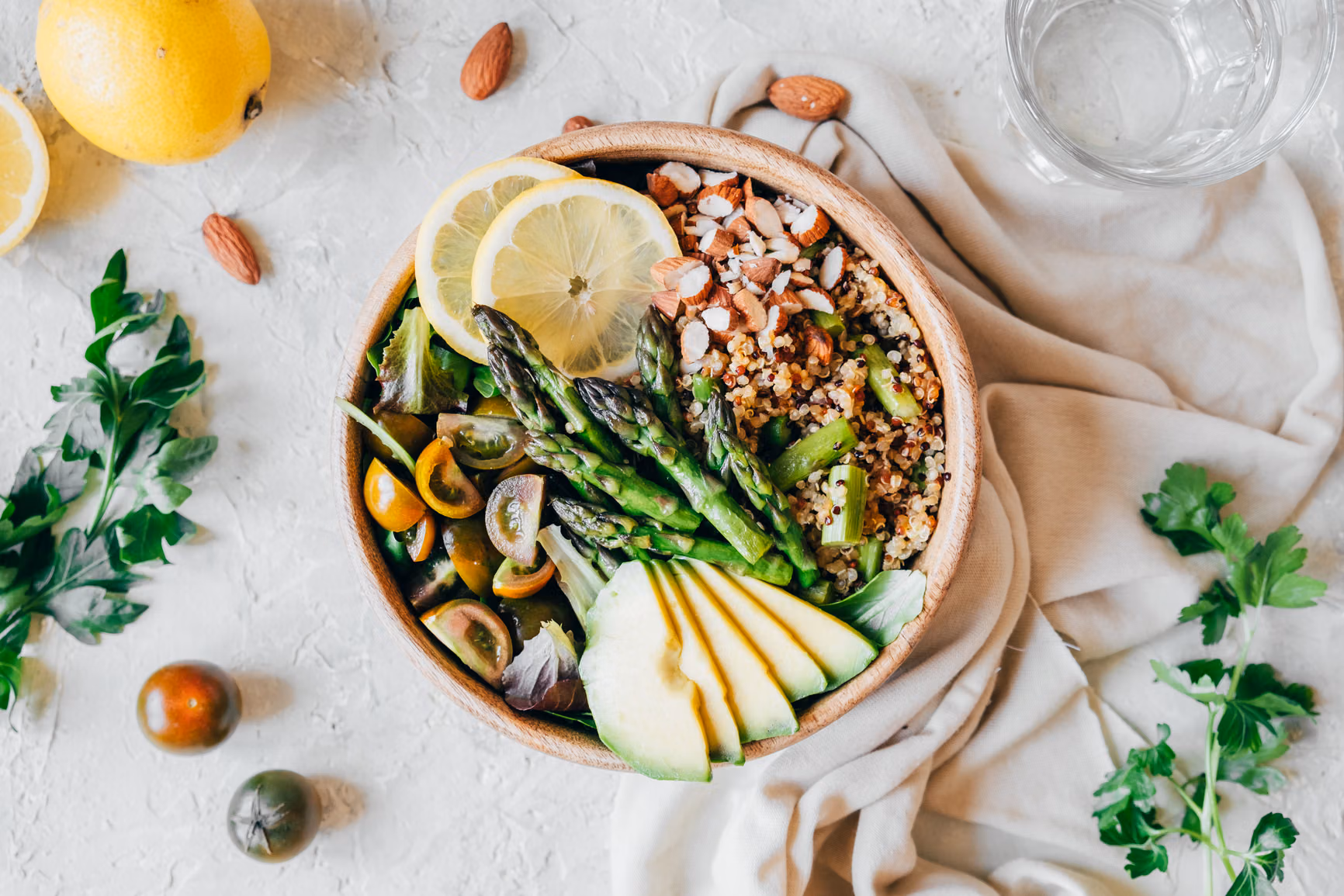 Bowl of veggies, tomatoes, avocado and grains.