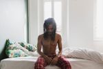 Man sleeping on bed doing breathing exercises for sleep.